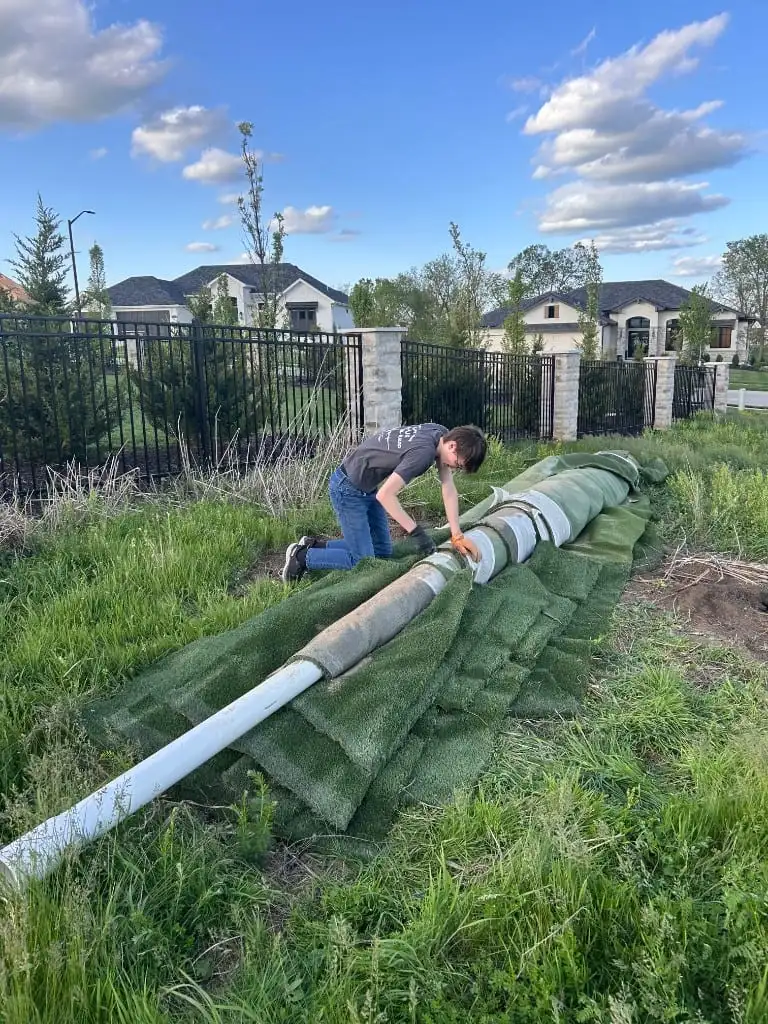 Junk removal crew hauling away old artificial turf